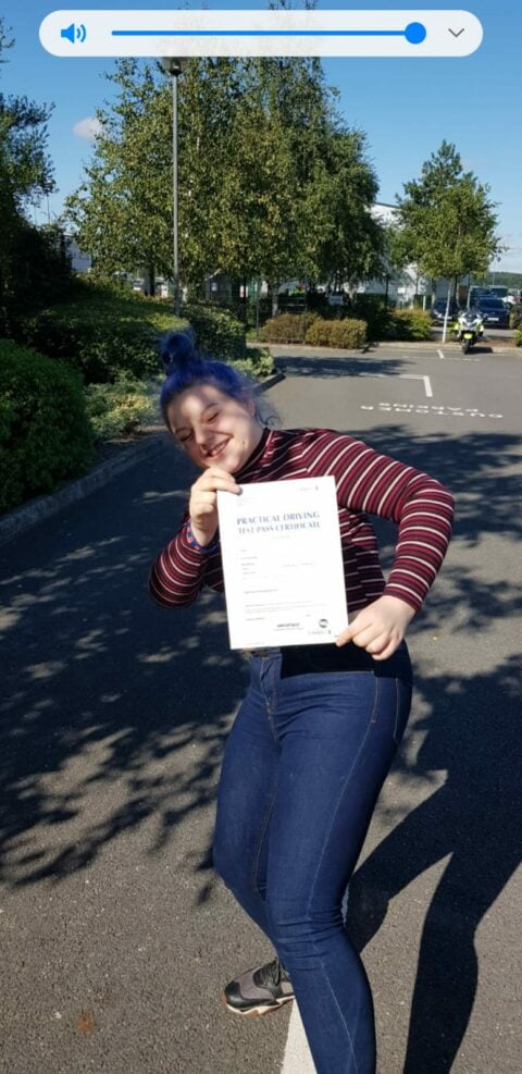 Roadcraft student holding driving test pass certificate