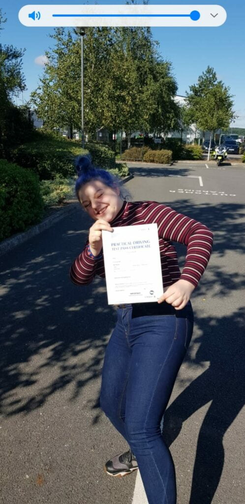 Roadcraft student holding driving test pass certificate