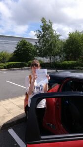 Roadcraft student holding driving test pass certificate