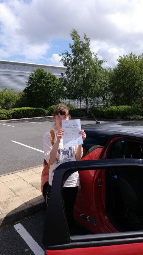 Roadcraft student holding driving test pass certificate